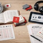 Ilustrasi persiapan JLPT dan JFT-Basic untuk SSW 2026 dengan materi belajar bahasa Jepang, lembar ujian, dan perangkat audio